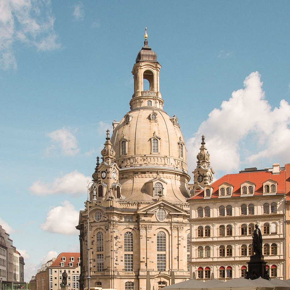 Die Frauenkirche der Stadt Dresden ragt über die Dächer aller Häuser.